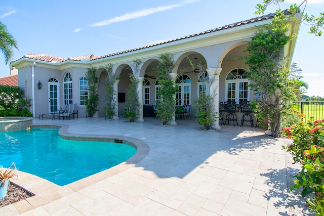 view of pool with french doors and a patio area