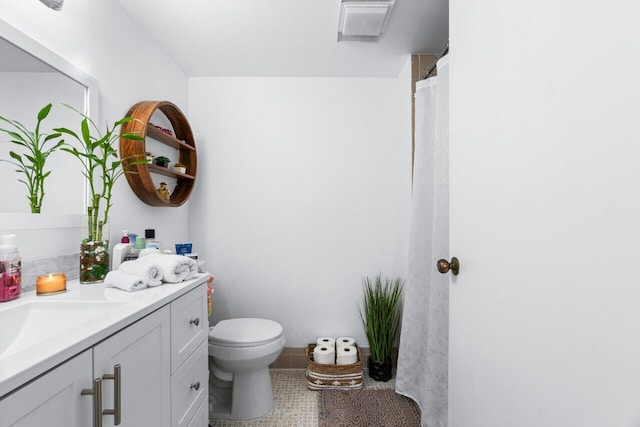 bathroom with vanity, toilet, and tile patterned floors