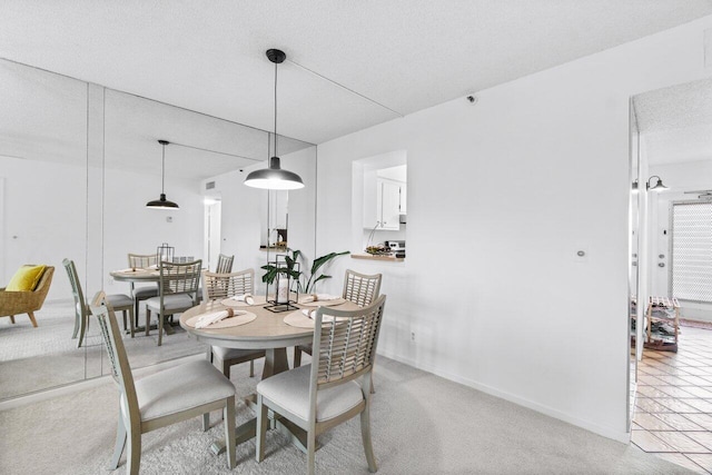 dining area featuring carpet and a textured ceiling