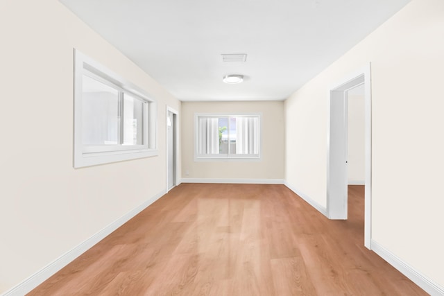 spare room featuring light hardwood / wood-style floors