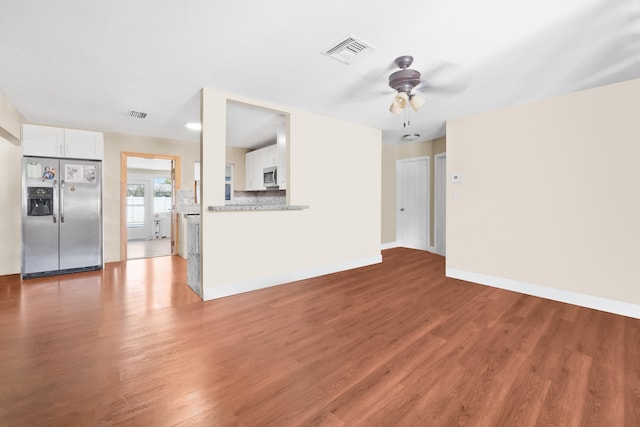 unfurnished living room with hardwood / wood-style floors and ceiling fan