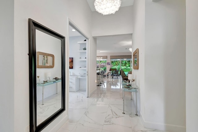 corridor with an inviting chandelier