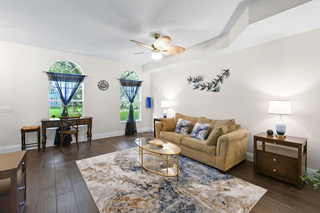 living room with dark wood-style floors, ceiling fan, and baseboards