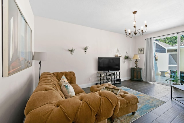 living area with a chandelier, dark wood finished floors, and baseboards