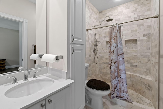 bathroom featuring toilet, a shower stall, and vanity