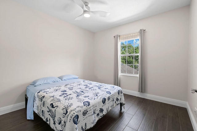 bedroom featuring dark wood-style floors, ceiling fan, and baseboards