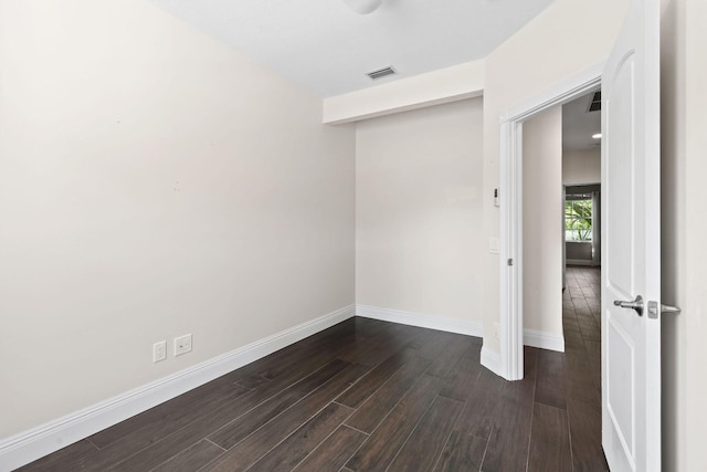 interior space featuring dark wood-style floors, visible vents, and baseboards