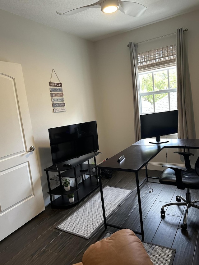 office area with dark wood-style flooring and ceiling fan