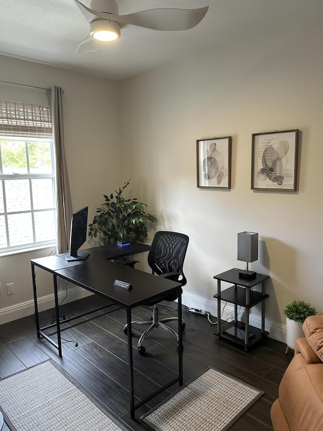 office space featuring a ceiling fan, dark wood finished floors, and baseboards