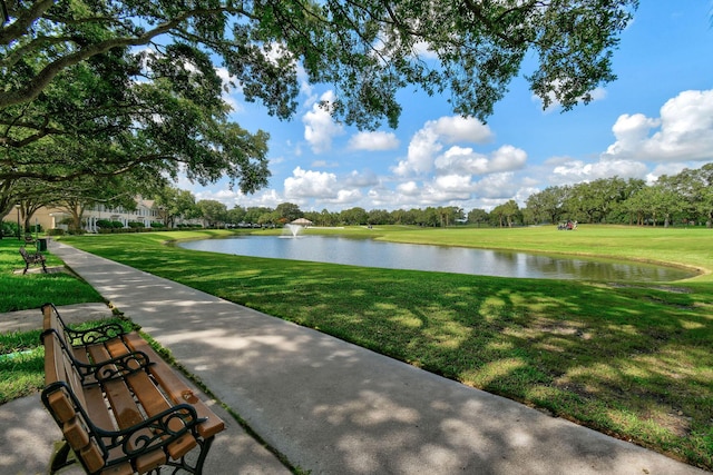 view of community featuring a water view and a yard