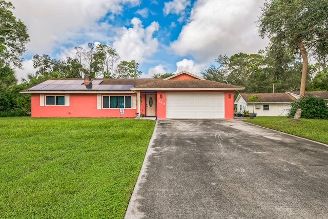 ranch-style home with a front lawn and a garage