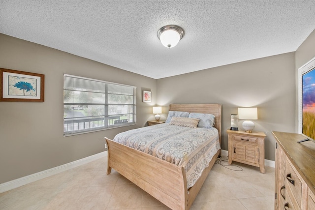 bedroom with a textured ceiling and light tile patterned flooring