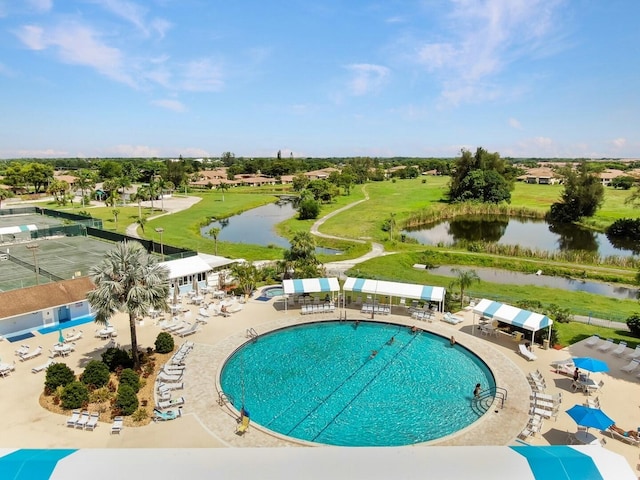 view of pool featuring a water view and a patio area