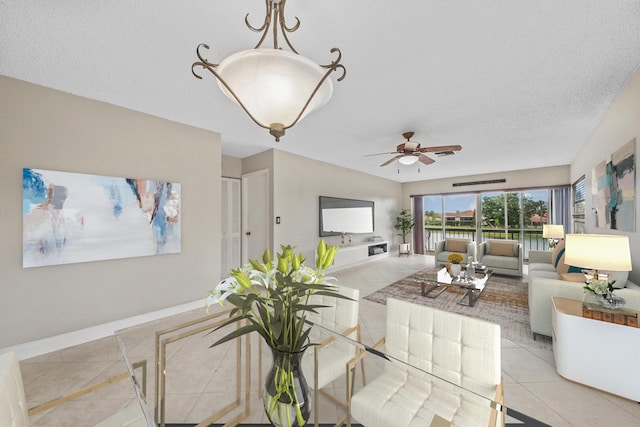 interior space featuring ceiling fan and a textured ceiling