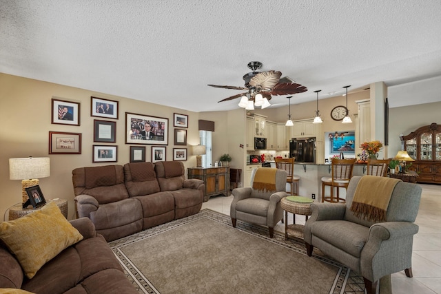 tiled living room featuring ceiling fan and a textured ceiling