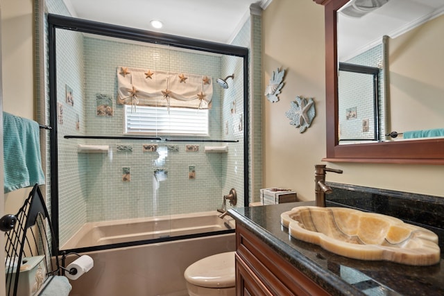 full bathroom featuring vanity, toilet, crown molding, and enclosed tub / shower combo