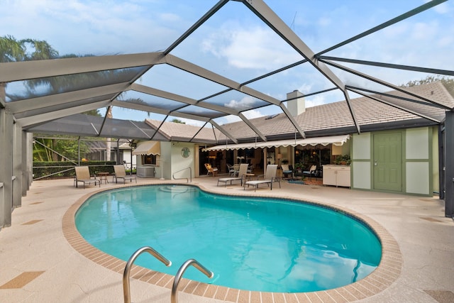 view of pool with a lanai and a patio