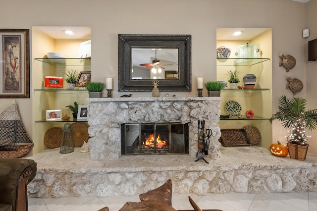 living room with ceiling fan and a fireplace