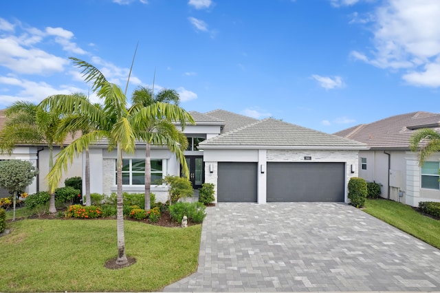 view of front facade with a garage and a front lawn