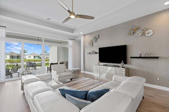 living room with hardwood / wood-style flooring and ceiling fan