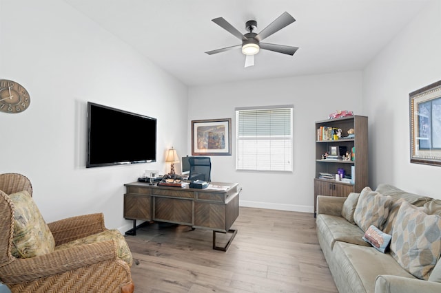 office featuring light hardwood / wood-style floors and ceiling fan