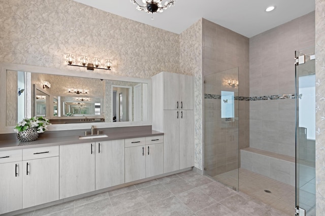 bathroom featuring tile patterned floors, vanity, and a shower with shower door