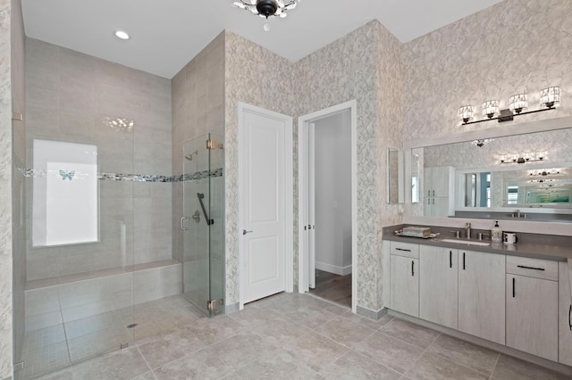 bathroom featuring tile patterned floors, vanity, and a shower with shower door