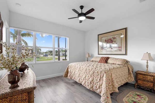 bedroom with ceiling fan and wood-type flooring