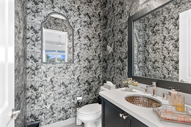 bathroom with vanity, ceiling fan, and toilet