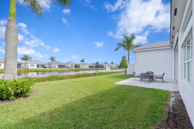 view of yard with a patio and a water view