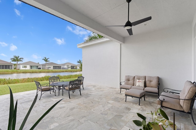 view of patio with ceiling fan, a water view, and an outdoor hangout area