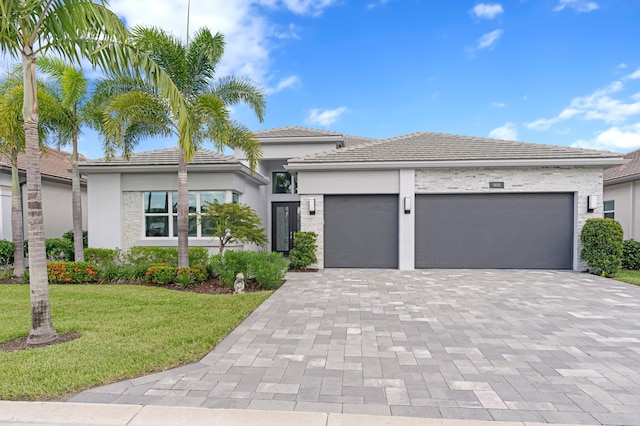 view of front of property with a front yard and a garage