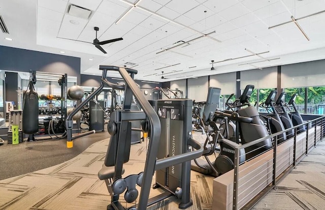 workout area featuring ceiling fan and light colored carpet