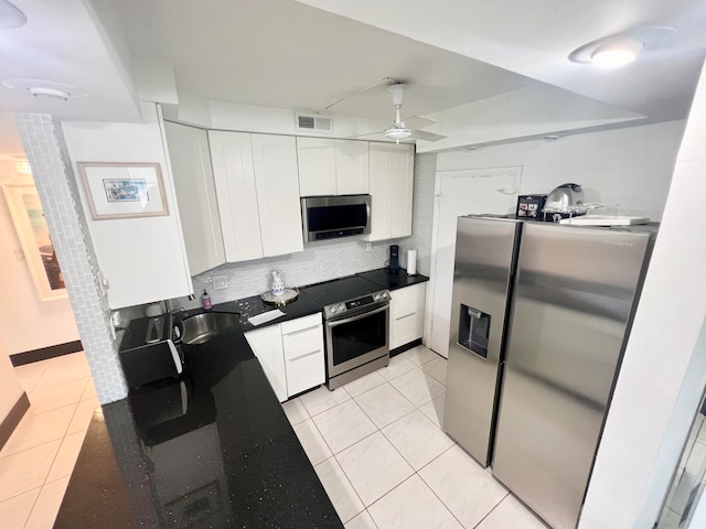 kitchen featuring backsplash, sink, white cabinetry, appliances with stainless steel finishes, and ceiling fan