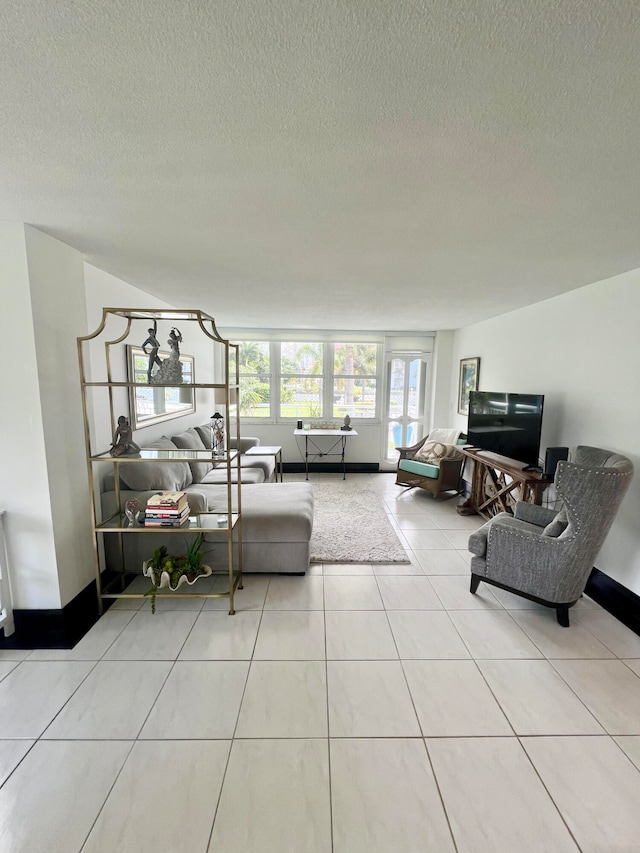 living room with a textured ceiling and light tile patterned floors