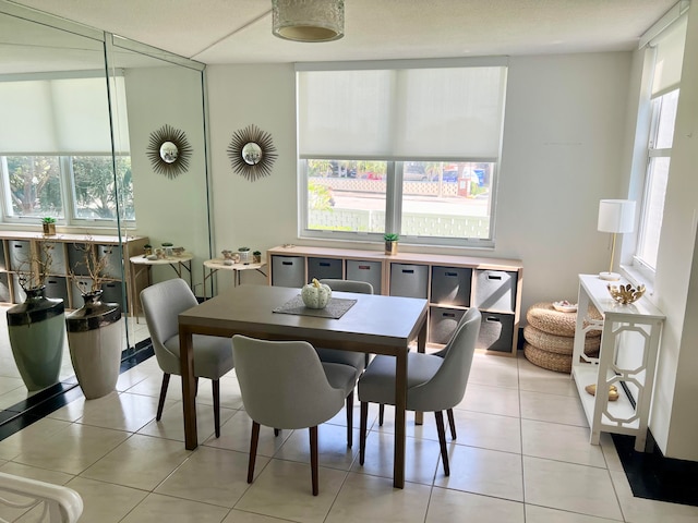 dining space featuring light tile patterned floors