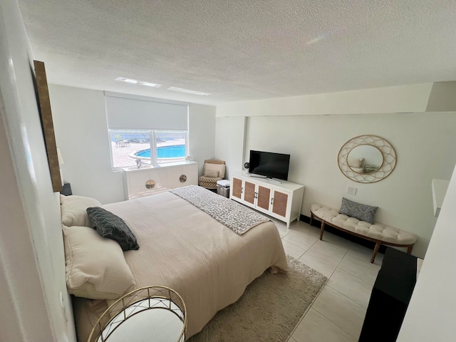 bedroom featuring a textured ceiling and light tile patterned flooring