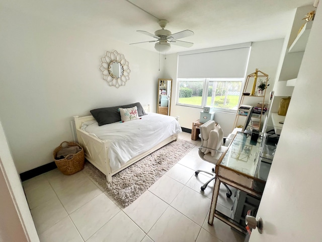 tiled bedroom featuring ceiling fan