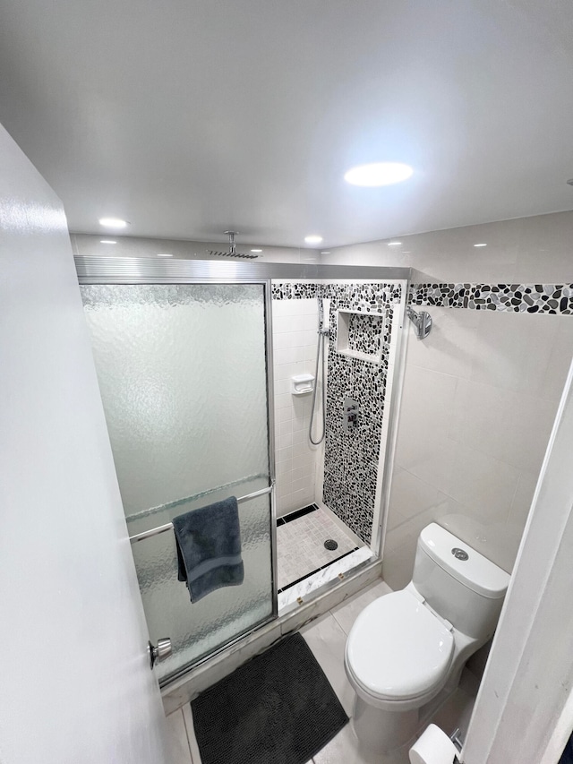 bathroom with tile patterned floors, toilet, and walk in shower