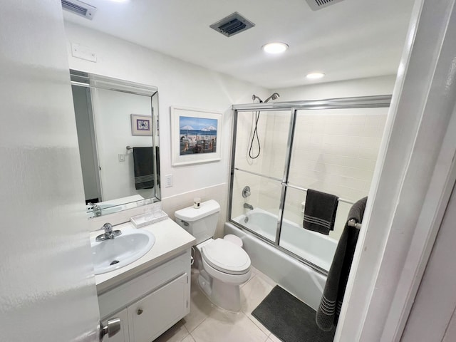 full bathroom with vanity, toilet, tile patterned floors, and shower / bath combination with glass door