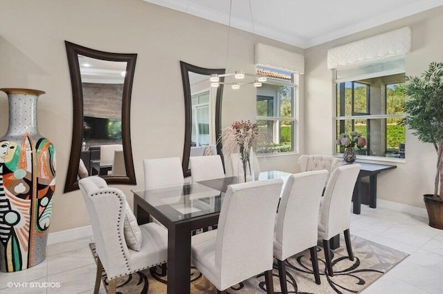 dining space featuring ornamental molding and light tile patterned flooring