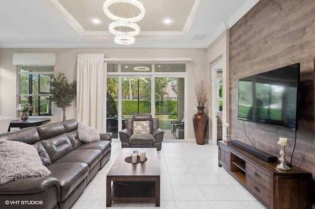 living room with a chandelier, a tray ceiling, and light tile patterned floors