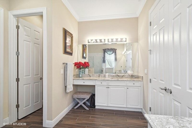 bathroom with vanity, hardwood / wood-style flooring, and ornamental molding