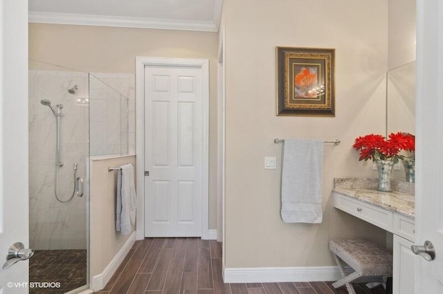 bathroom with hardwood / wood-style flooring, a shower with shower door, vanity, and crown molding