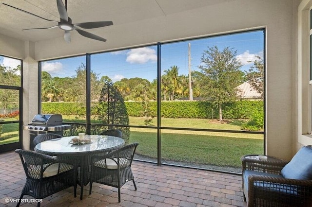 sunroom featuring ceiling fan