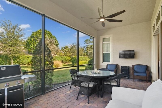 sunroom featuring ceiling fan