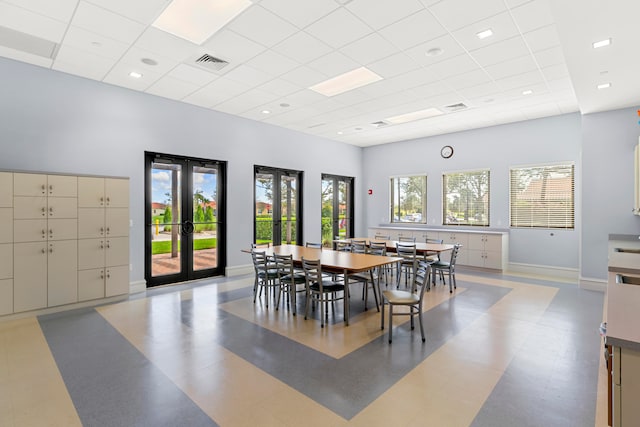 dining area featuring plenty of natural light, french doors, and a paneled ceiling