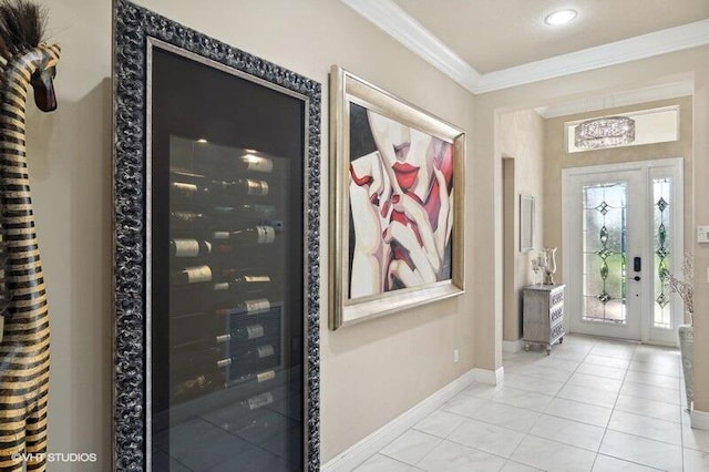 foyer with light tile patterned flooring, french doors, and ornamental molding