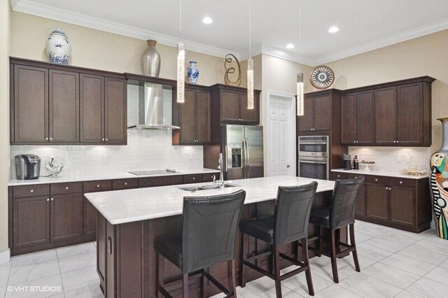 kitchen featuring sink, an island with sink, stainless steel fridge with ice dispenser, black electric stovetop, and wall chimney range hood