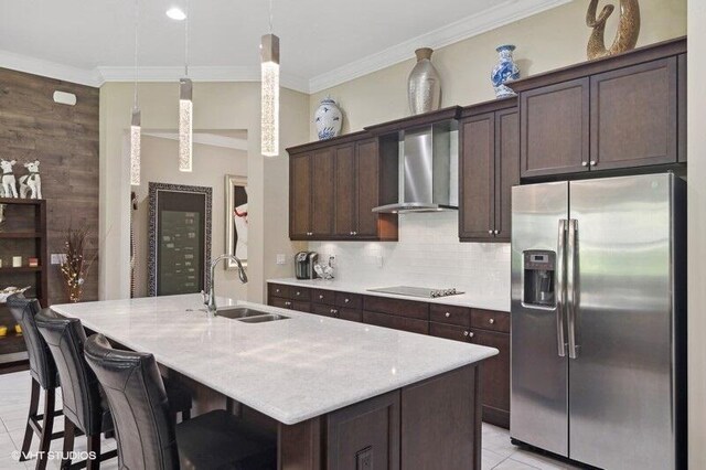 kitchen featuring ornamental molding, stainless steel appliances, decorative backsplash, sink, and wall chimney exhaust hood